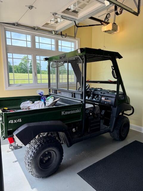 1038 Lees Mill Ln, Goode, VA 24556 - garage featuring a garage door opener and baseboards
