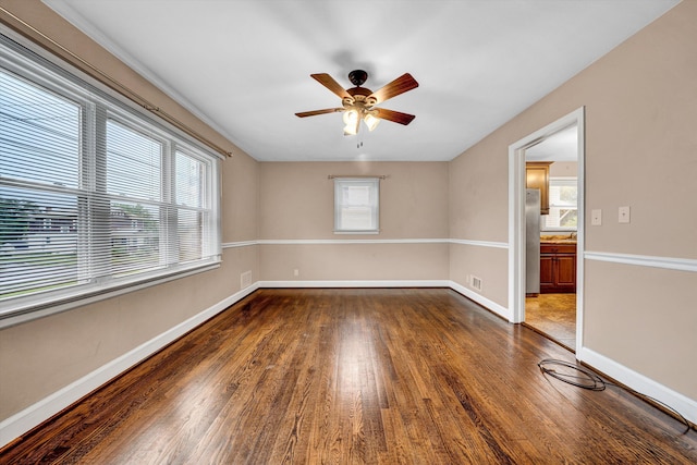 130 W Augusta Ave, Vinton, VA 24179 - spare room with ceiling fan, dark wood-style floors, and baseboards