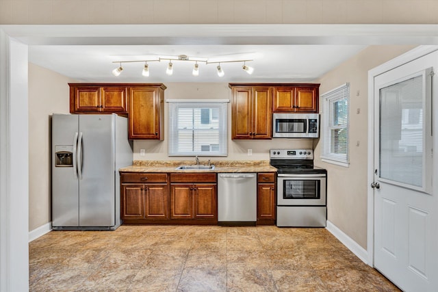 130 W Augusta Ave, Vinton, VA 24179 - kitchen with appliances with stainless steel finishes, brown cabinetry, and healthy amount of natural light