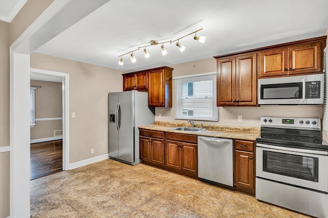 130 W Augusta Ave, Vinton, VA 24179 - kitchen featuring appliances with stainless steel finishes, a sink, brown cabinets, and light countertops