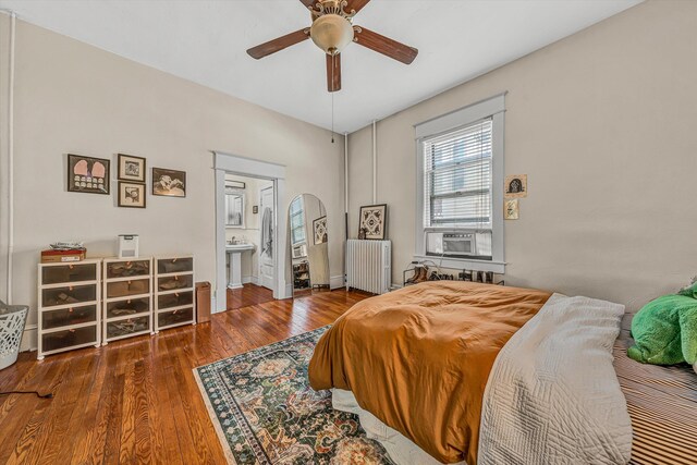 602 Allison Ave SW, Roanoke, VA 24016 - bedroom featuring radiator, arched walkways, wood finished floors, cooling unit, and ceiling fan