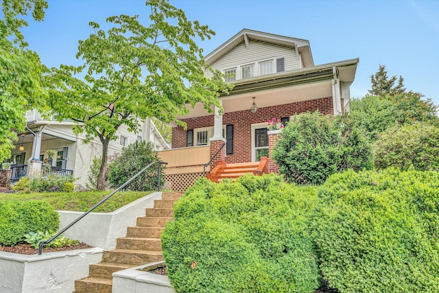 1129 Howbert Ave SW, Roanoke, VA 24015 - view of front of home featuring brick siding, covered porch, and stairs
