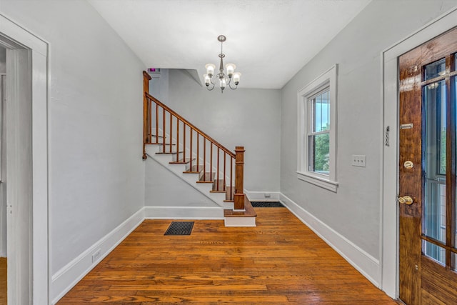 1129 Howbert Ave SW, Roanoke, VA 24015 - foyer with wood finished floors, a chandelier, stairway, and baseboards