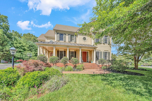 1160 Belcroft Ct, Roanoke, VA 24018 - colonial inspired home featuring a porch, a standing seam roof, a front yard, a metal roof, and roof with shingles