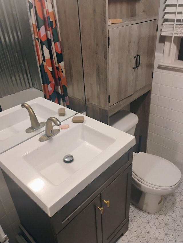 2415 Longview Ave SW Unit 1, Roanoke, VA 24014 - bathroom featuring vanity, toilet, tile walls, and tile patterned flooring