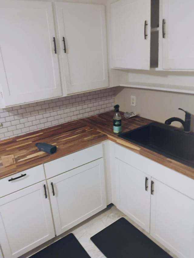 2415 Longview Ave SW Unit 1, Roanoke, VA 24014 - kitchen featuring butcher block countertops, white cabinetry, decorative backsplash, and a sink