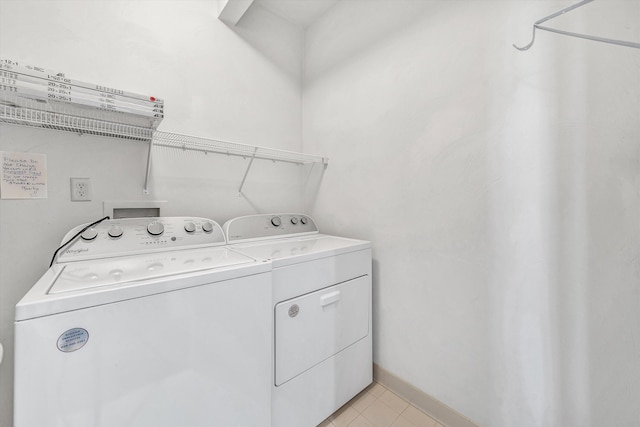 3303 Belshire Ct SW, Roanoke, VA 24014 - laundry room featuring washing machine and clothes dryer, light tile patterned floors, and baseboards