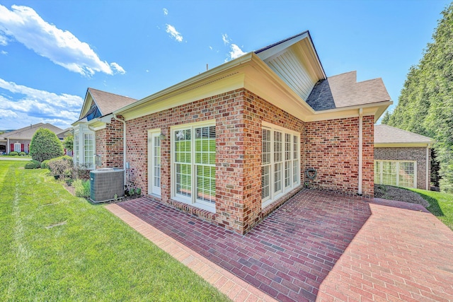 3303 Belshire Ct SW, Roanoke, VA 24014 - view of side of property with central AC, a patio area, a yard, brick siding, and a shingled roof