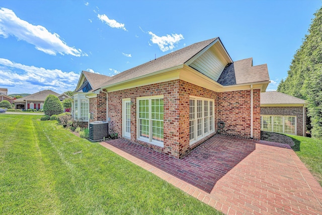 3303 Belshire Ct SW, Roanoke, VA 24014 - view of property exterior with a patio area, a lawn, central AC unit, brick siding, and a shingled roof