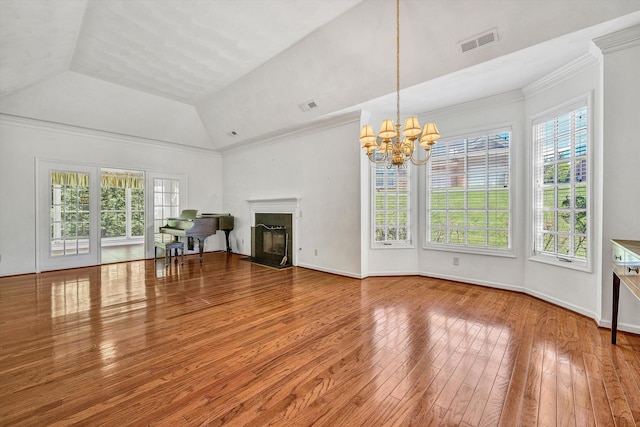 3303 Belshire Ct SW, Roanoke, VA 24014 - unfurnished living room featuring plenty of natural light, hardwood / wood-style floors, a chandelier, a glass covered fireplace, and vaulted ceiling