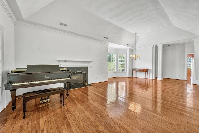 3303 Belshire Ct SW, Roanoke, VA 24014 - living room with a chandelier, vaulted ceiling, wood finished floors, a fireplace with flush hearth, and baseboards