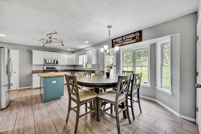 135 Sapphire Ave, Christiansburg, VA 24073 - dining space with a chandelier, baseboards, wood tiled floors, and recessed lighting
