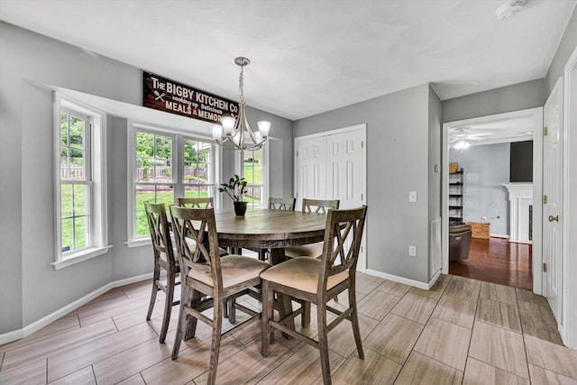135 Sapphire Ave, Christiansburg, VA 24073 - dining area featuring wood tiled floors, healthy amount of natural light, a chandelier, and baseboards