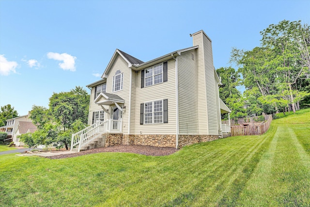 135 Sapphire Ave, Christiansburg, VA 24073 - view of front of property with a chimney, a front yard, and stone siding