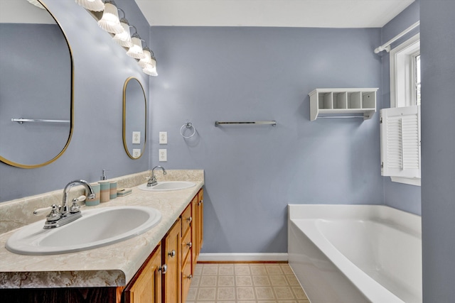 135 Sapphire Ave, Christiansburg, VA 24073 - bathroom featuring a bath, double vanity, and baseboards
