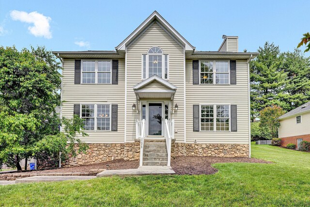 135 Sapphire Ave, Christiansburg, VA 24073 - view of front of property with a chimney, a front lawn, and stone siding