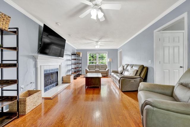 135 Sapphire Ave, Christiansburg, VA 24073 - living room with ceiling fan, wood finished floors, a tiled fireplace, and ornamental molding