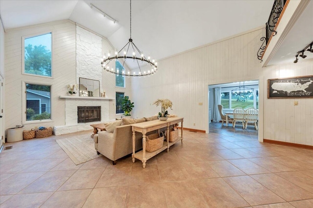 20728 Virgil H Goode Hwy, Rocky Mount, VA 24151 - living room featuring a chandelier, high vaulted ceiling, light tile patterned floors, wooden walls, and track lighting