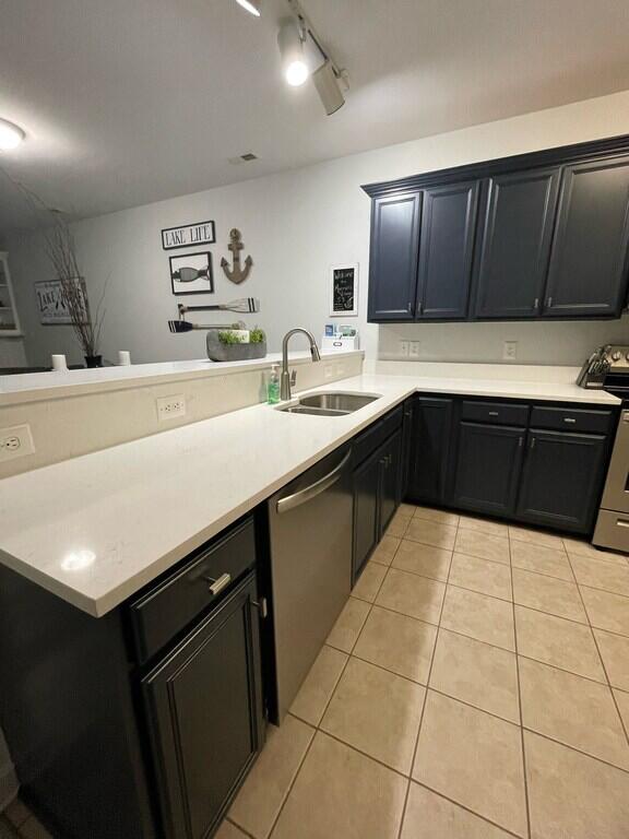 1175 Mariners Way Unit 58, Huddleston, VA 24104 - kitchen featuring a sink, stainless steel appliances, a peninsula, light tile patterned flooring, and light countertops
