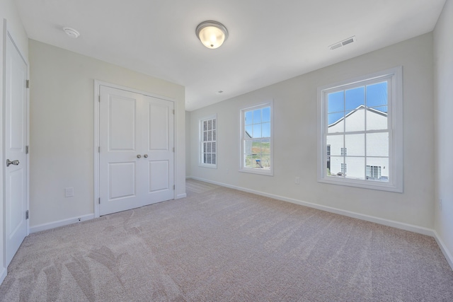 5255 Arrowhead Trl, Salem, VA 24153 - unfurnished bedroom with light carpet, baseboards, and a closet