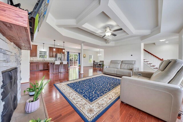 7019 Linn Cove Ct, Roanoke, VA 24018 - living area with a stone fireplace, dark wood-type flooring, coffered ceiling, ceiling fan, and ornamental molding