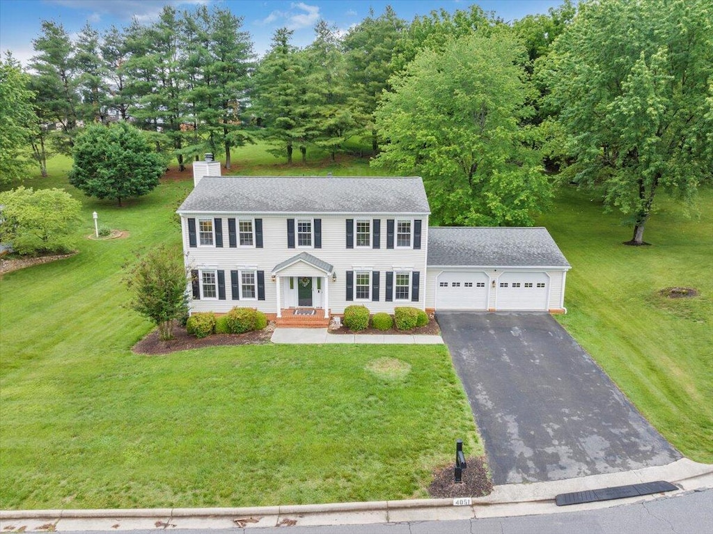 4051 Snowgoose Cir, Roanoke, VA 24018 - colonial-style house with an attached garage, a chimney, driveway, and roof with shingles