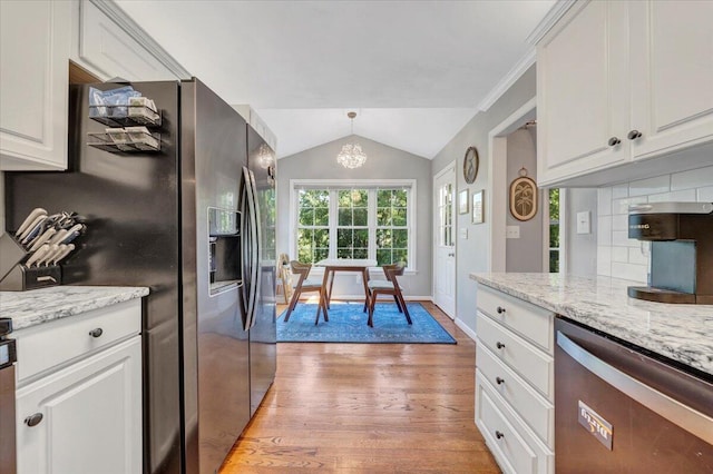 828 Ray St, Roanoke, VA 24019 - kitchen with appliances with stainless steel finishes, light wood-style flooring, vaulted ceiling, white cabinets, and light stone counters