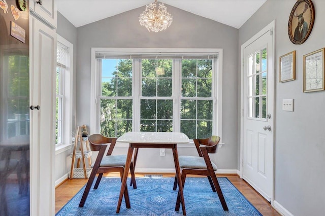 828 Ray St, Roanoke, VA 24019 - dining room with wood finished floors, healthy amount of natural light, vaulted ceiling, a chandelier, and baseboards