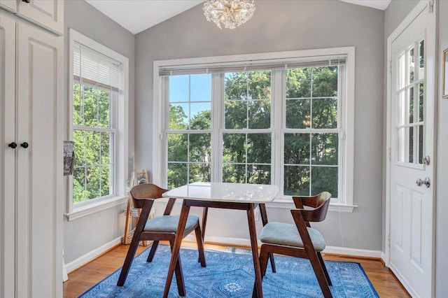 828 Ray St, Roanoke, VA 24019 - dining area with baseboards, wood finished floors, lofted ceiling, and a chandelier