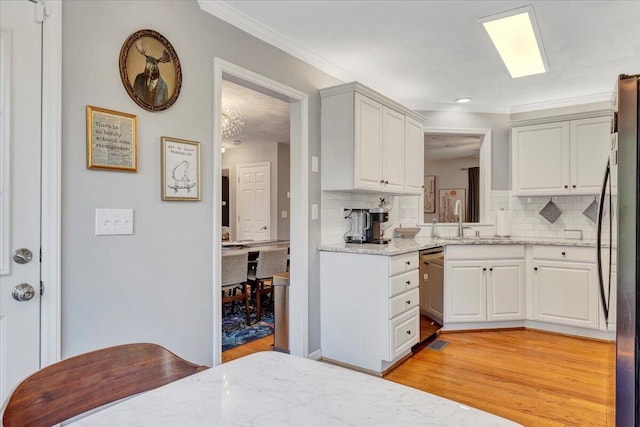 828 Ray St, Roanoke, VA 24019 - kitchen with stainless steel dishwasher, ornamental molding, tasteful backsplash, fridge, and light stone countertops