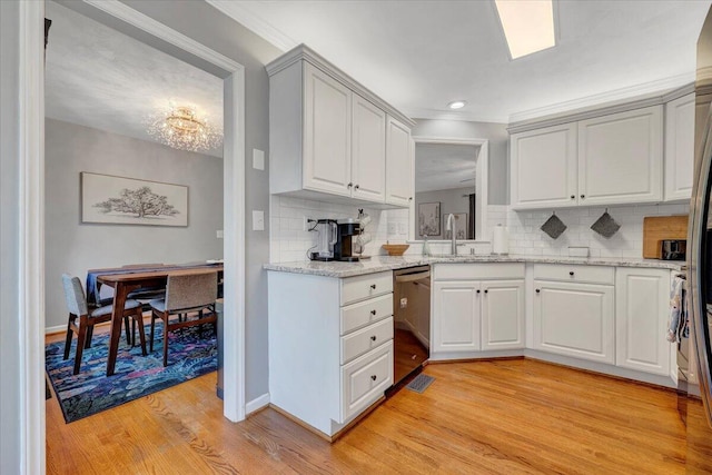 828 Ray St, Roanoke, VA 24019 - kitchen featuring a sink, light wood finished floors, stainless steel dishwasher, decorative backsplash, and recessed lighting