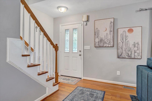 828 Ray St, Roanoke, VA 24019 - foyer entrance with wood finished floors, stairway, and baseboards