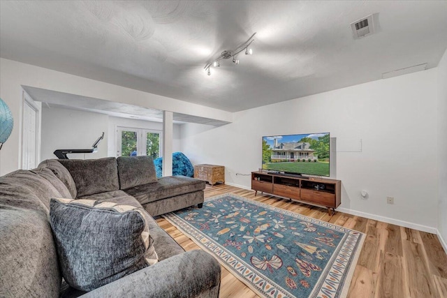 828 Ray St, Roanoke, VA 24019 - living room with french doors, wood finished floors, baseboards, and track lighting