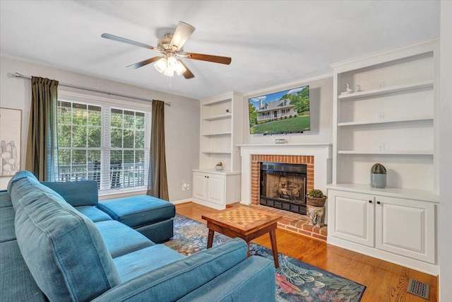 828 Ray St, Roanoke, VA 24019 - living area with ceiling fan, built in features, light wood finished floors, a fireplace, and baseboards