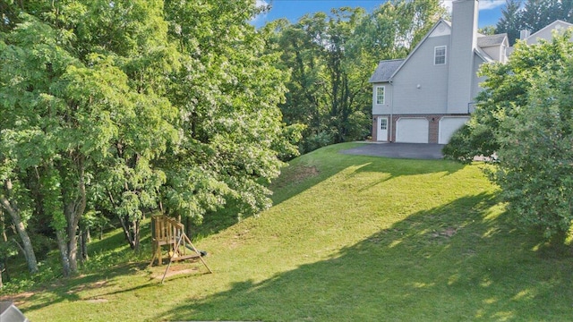 828 Ray St, Roanoke, VA 24019 - view of grassy yard with a garage and asphalt driveway