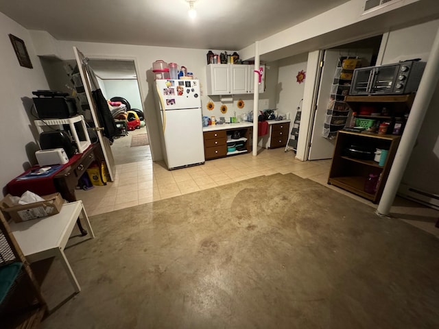 570 Scuffling Hill Rd, Rocky Mount, VA 24151 - kitchen with freestanding refrigerator and white cabinetry