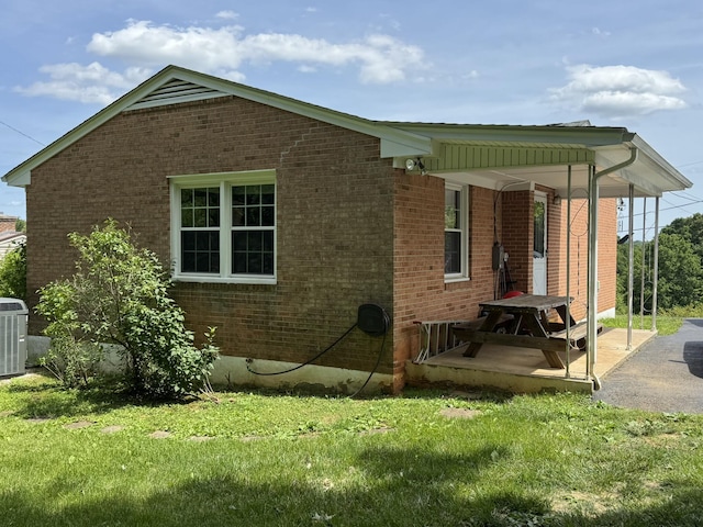 570 Scuffling Hill Rd, Rocky Mount, VA 24151 - view of home's exterior with brick siding, a yard, and central AC