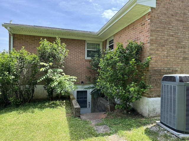 570 Scuffling Hill Rd, Rocky Mount, VA 24151 - view of property exterior featuring central AC, a yard, and brick siding