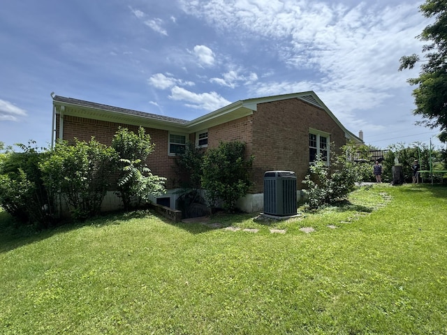 570 Scuffling Hill Rd, Rocky Mount, VA 24151 - view of side of property featuring brick siding, central air condition unit, and a yard