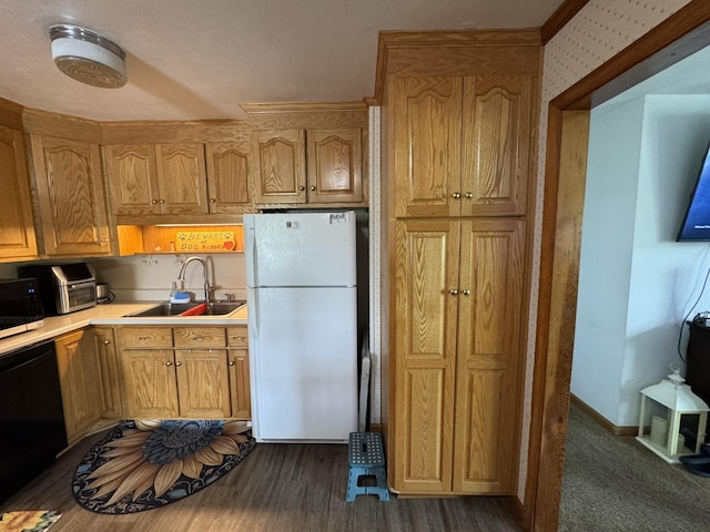 570 Scuffling Hill Rd, Rocky Mount, VA 24151 - kitchen featuring freestanding refrigerator, a sink, black dishwasher, light countertops, and dark wood-style flooring