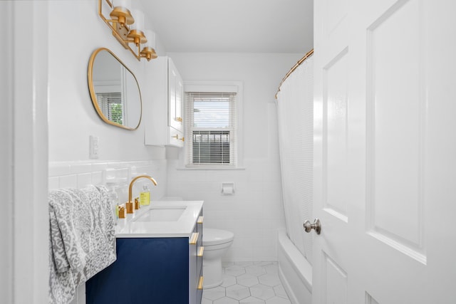 2561 Inglewood Rd SW, Roanoke, VA 24015 - full bathroom featuring vanity, tile walls, tile patterned floors, toilet, and wainscoting