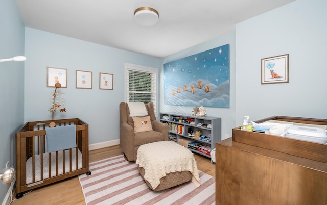 2561 Inglewood Rd SW, Roanoke, VA 24015 - bedroom with wood finished floors, a nursery area, and baseboards