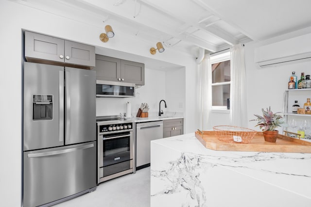 2561 Inglewood Rd SW, Roanoke, VA 24015 - kitchen with appliances with stainless steel finishes, an AC wall unit, gray cabinets, concrete floors, and a sink