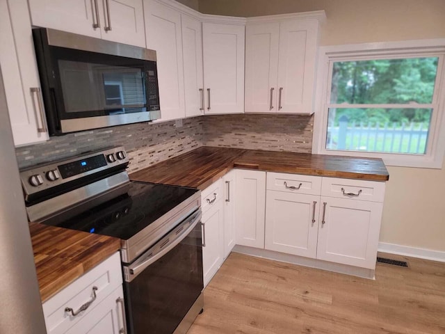640 Cooks Knob Rd, Ferrum, VA 24088 - kitchen featuring appliances with stainless steel finishes, wooden counters, decorative backsplash, and light wood-style floors