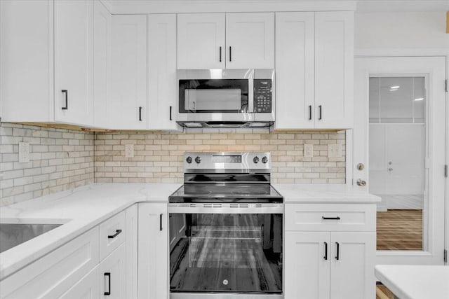 201 Forest Ridge Dr, Vinton, VA 24179 - kitchen with stainless steel appliances, white cabinets, tasteful backsplash, and light stone counters