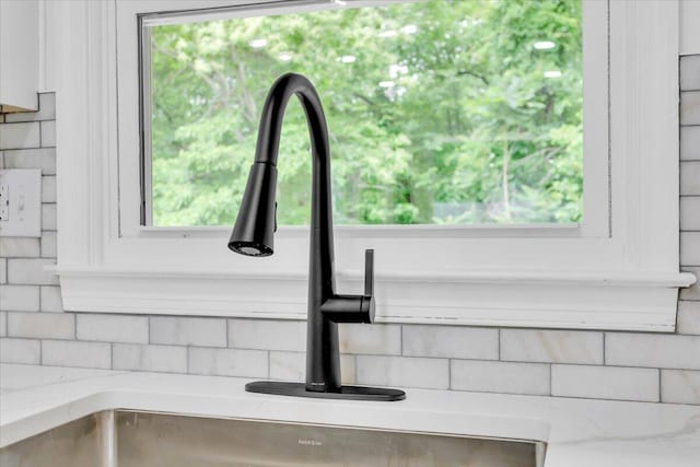 201 Forest Ridge Dr, Vinton, VA 24179 - kitchen view of decorative backsplash, a sink, and light stone counters
