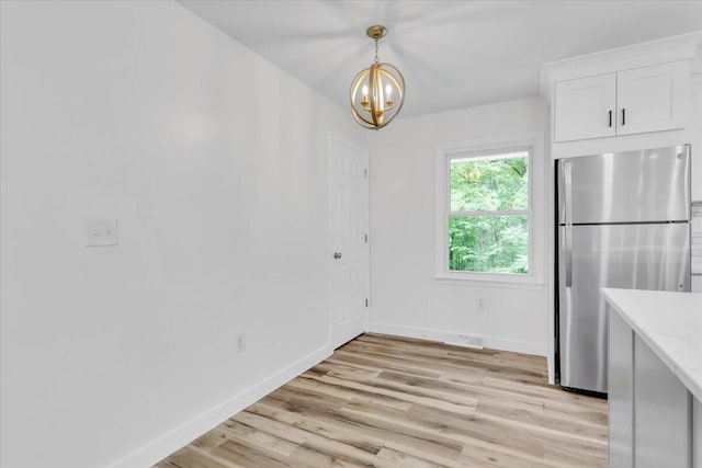 201 Forest Ridge Dr, Vinton, VA 24179 - unfurnished dining area featuring baseboards, a chandelier, and light wood-style floors