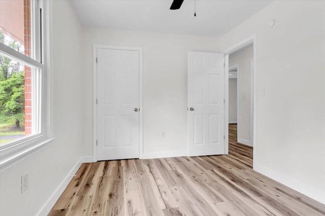 201 Forest Ridge Dr, Vinton, VA 24179 - unfurnished bedroom featuring multiple windows, baseboards, light wood finished floors, and a ceiling fan
