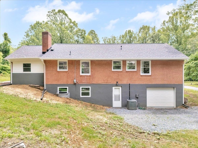 201 Forest Ridge Dr, Vinton, VA 24179 - back of house with a chimney, central AC, an attached garage, brick siding, and driveway