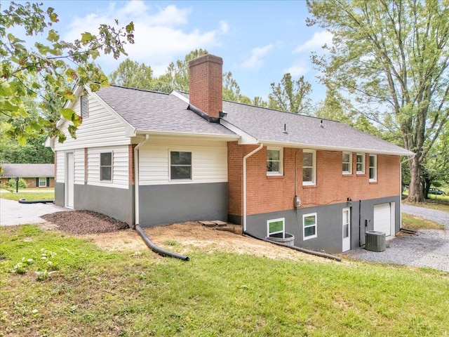 201 Forest Ridge Dr, Vinton, VA 24179 - back of house featuring a chimney, an attached garage, a yard, brick siding, and cooling unit